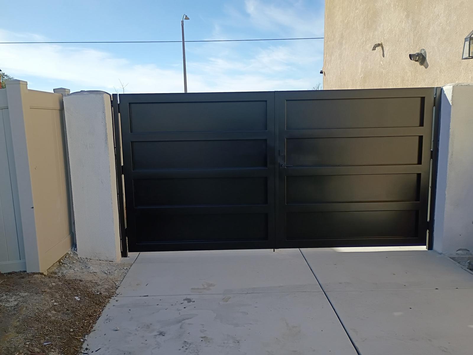 Custom black steel double driveway gate with horizontal panels in Palm Desert