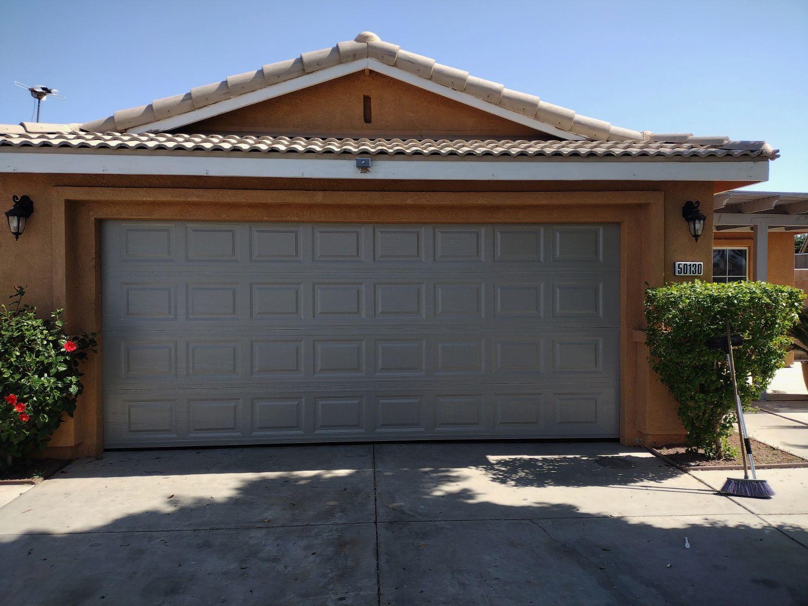 Grey raised-panel garage door installation on a tile-roof home in Rancho Mirage